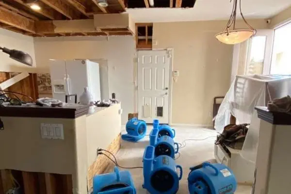 Air movers drying a great room after a storm leak in Encino